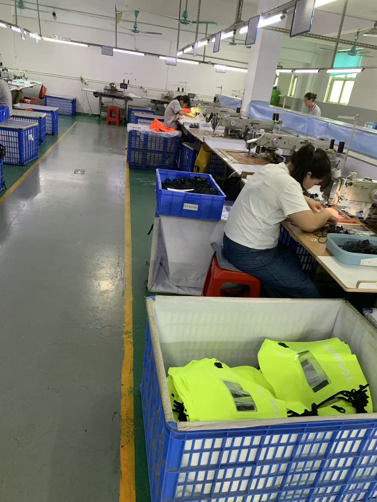 Crates of finished buoys staged along the production aisle